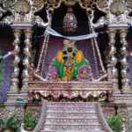 Lord Banke Bihari sitting in a swing made of gold and silver