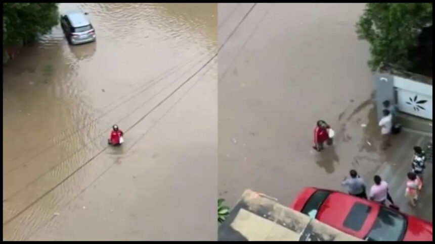 Zomato delivery agent delivers food by walking through flood waters in Ahmedabad